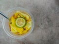 A bowl of healthy fresh fruit salad, made from sliced Ã¢â¬â¹Ã¢â¬â¹pineapple, mango and lime, top view Royalty Free Stock Photo